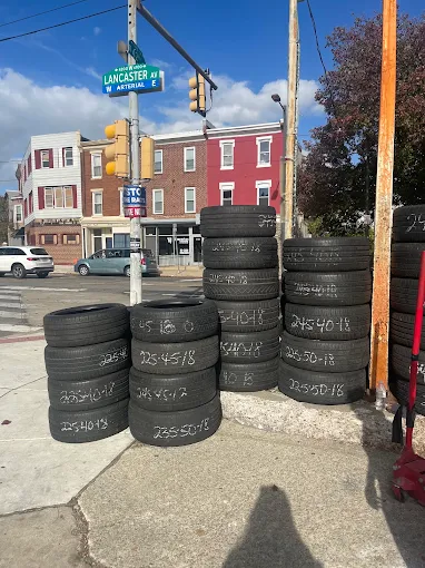 Stacks of tires marked with sizes on the corner of Lancaster Ave